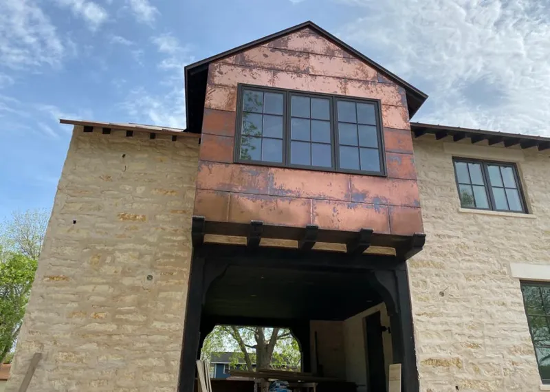 Copper metal panel facade on a stone building for Roof Repair in Isla Vista